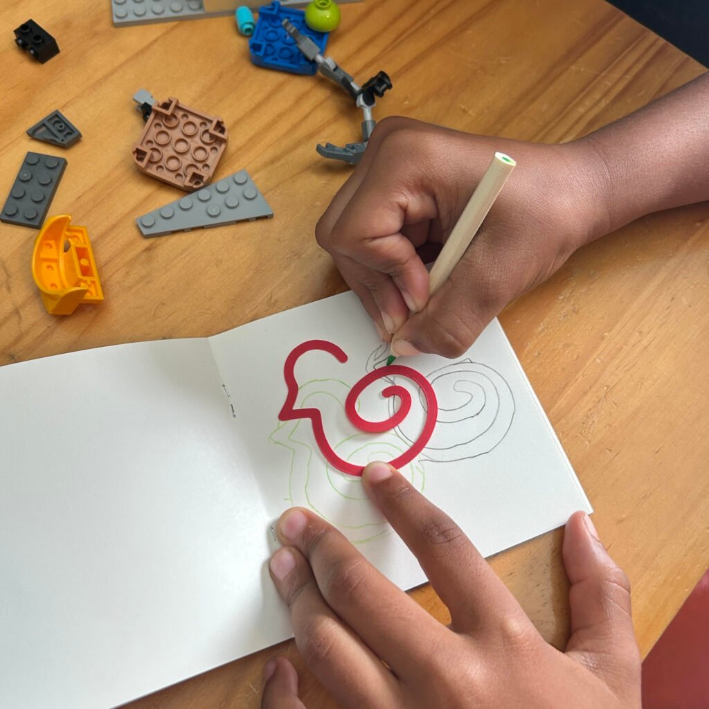 Child using Duck-links to trace in a notebook